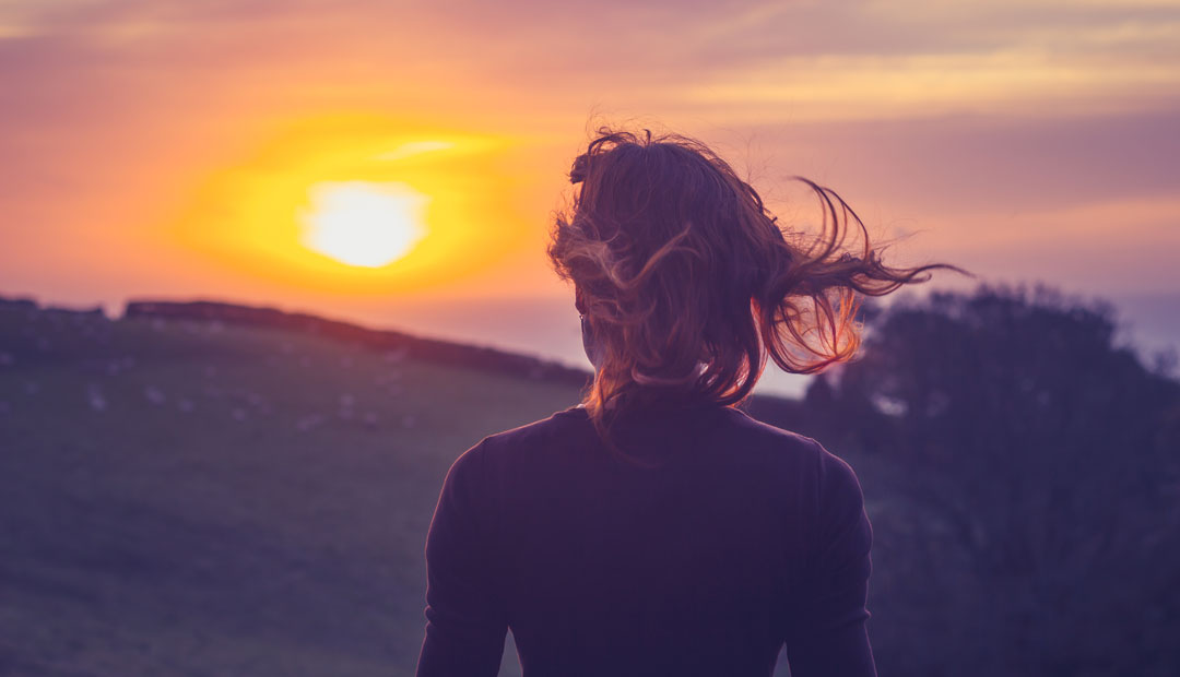 woman looking at sunrise
